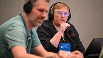 two people with headsets leading meeting