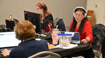 GA227 committee leadership team members with laptops and headphones