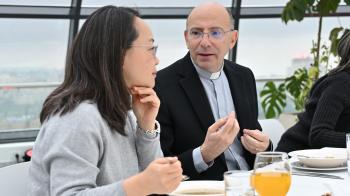 A man and a woman have a conversation at a table