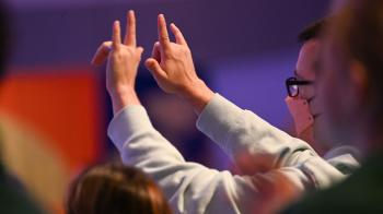 Person holding up love symbols with fingers at GA227