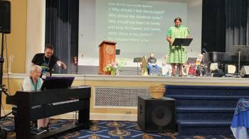 Mary Conklin plays while CeCe listens at Synod School