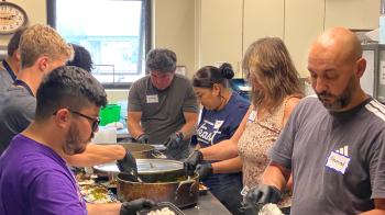 People gathered together, preparing food