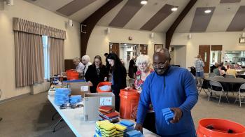 People standing around inside a church with storm supplies