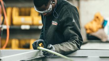 A man with safety-goggles does close-up work at a business