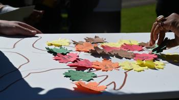 Members of Hillside Presbyterian Church add leaves of justice during a ritual of communal witness led by Young Adult Advocacy participants. (Photo by Jeff McAllister)  