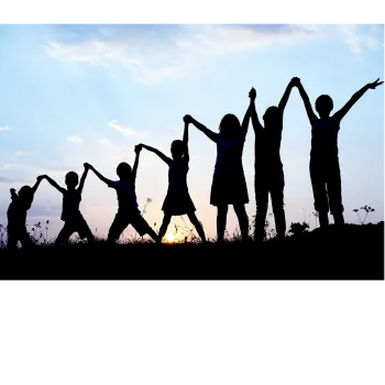 A line of children holding hands arms raised silhouetted against a blue sky. 