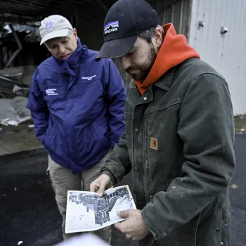 two people helping in a storm