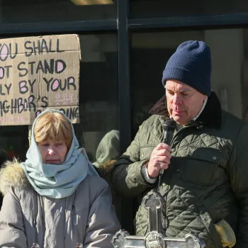 Dave Huting and Diane Rogers pray outside of Immigration and Customs Enforcement office.