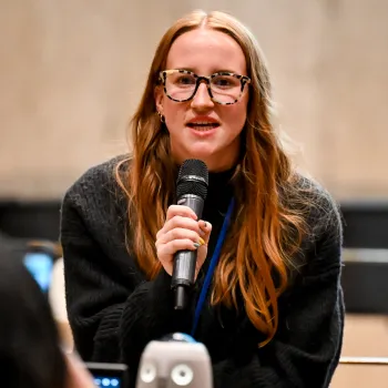 Woman speaking while holding a microphone