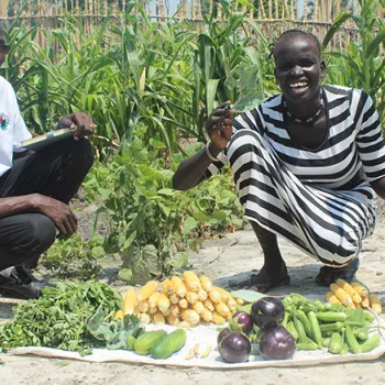 woman holding okra in garden