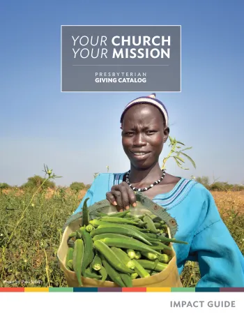 woman holding okra in garden