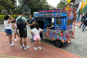 Family talking with a tuk-tuk driver in the colorful town of Guatape Colombia