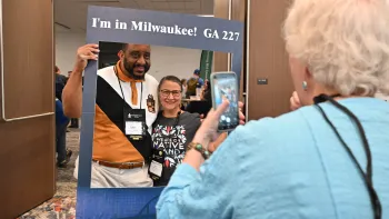 A man and woman have their picture taken in a frame that says Milwaukee
