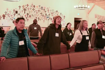 The Rev. Sunny Kang and Taylor Kang worship side by side at the 1001 NWC annual gathering.