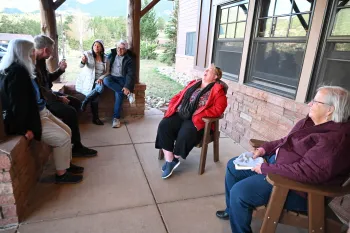 Despite winter-like temperatures and the long wait for room keys at the Emerald Mountain Lodge of the YMCA of the Rockies, participants engage in easy conversation and laughter.
