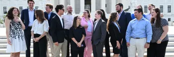 young adults standing and talking to each other