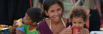 woman holding and feeding children
