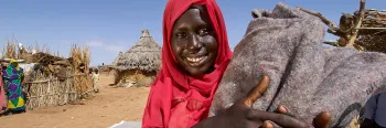smiling woman holding burlap bag