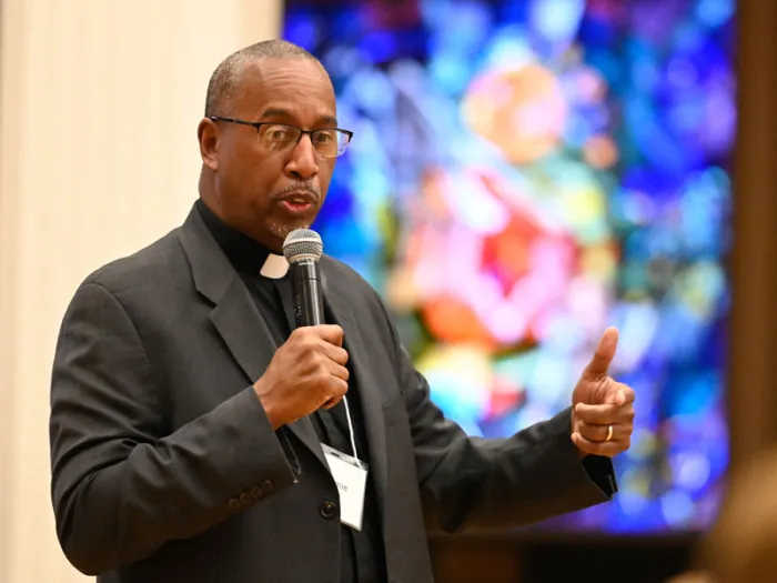 A man standing with a microphone