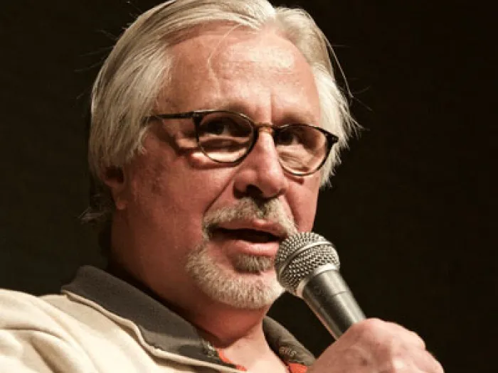 Rev. Brian Hamilton holding a microphone