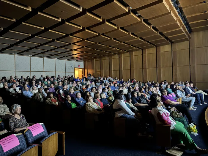 People gathered in an auditorium for a film showing