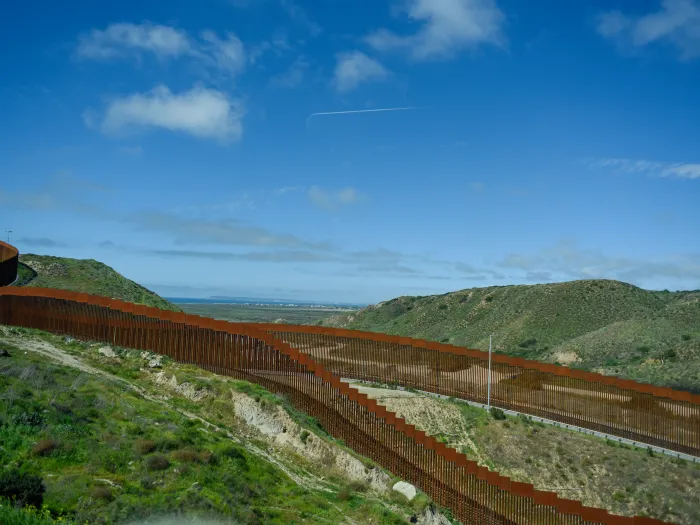 Green rolling hills and a blue sky at the U.S. southern border