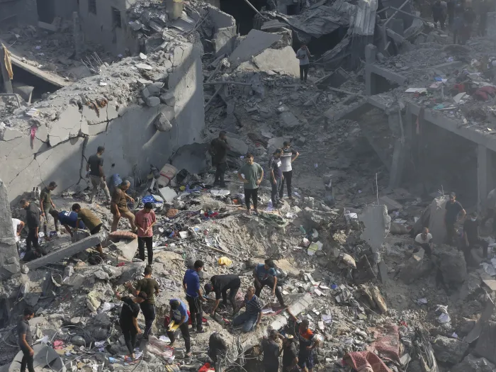 People standing amid rubble