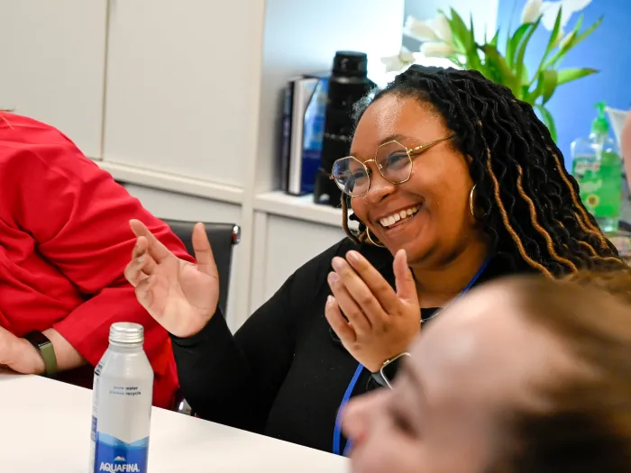 A young woman smiles during a conversation in the office of the Presbyterian Ministry to the United Nations. 