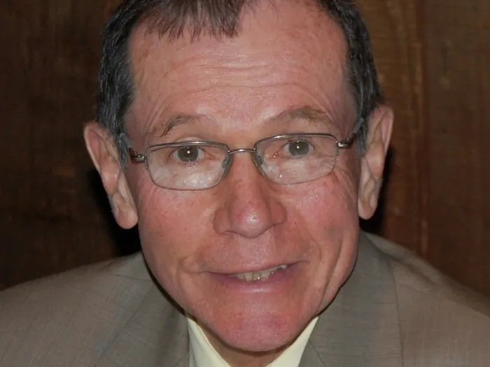 Headshot of man in suit and tie.
