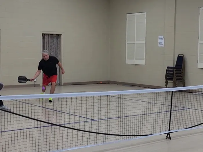two men are playing pickleball