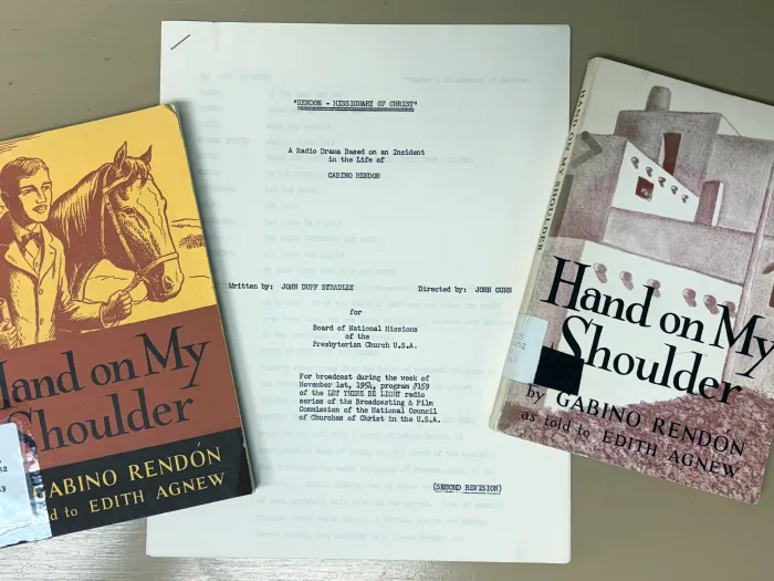 Two copies of a book titled Hand on My Shoulder, placed on each side of a document.
