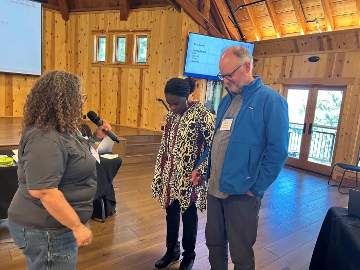 Rev. Marta Pumroy-Cordero prays with PL&W Board co-chairs