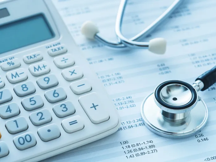 health illustration with stethescope, a bill and calculator