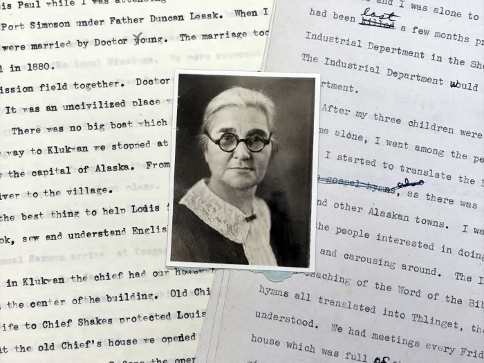 A small black and white photograph of Tillie Tamaree lies atop two typed autobiographical essays she wrote in 1948.