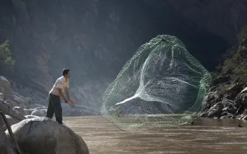 man casting fish net