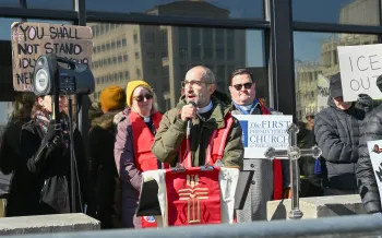 Pastor speaks to a crowd in front of the Philadelphia office of Immigration and Customs Enforcement.