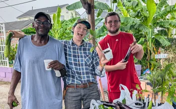 young adults holding harvest from the garden