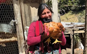 smiling woman holding chicken
