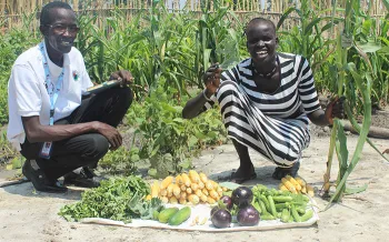 woman holding okra in garden