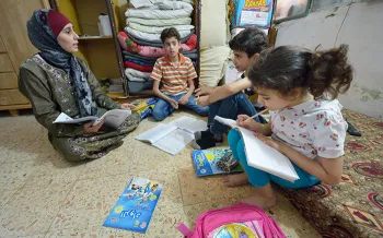 children being taught using text books