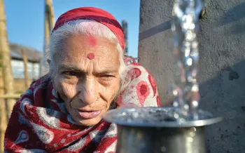 woman watching water flow from the spigot