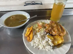 Lunch with soup and chicken, rice, plantains and cassava