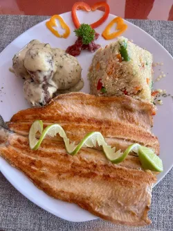 plate of baked trout with mushrooms and quinoa
