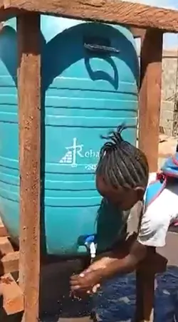 Children using an outdoor handwashing apparatus